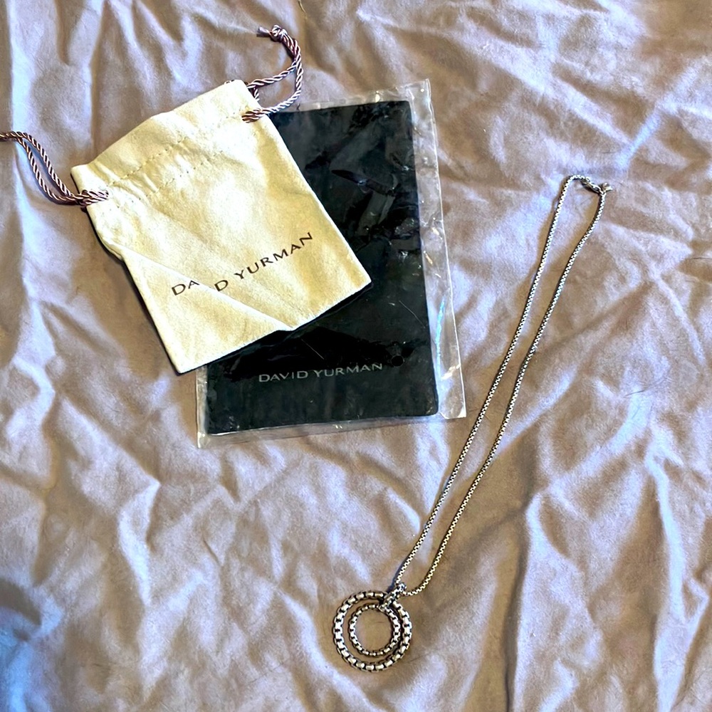 David Yurman sterling silver necklace with round pendant.